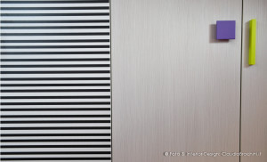 particolare armadio con strisce e maniglie colorate